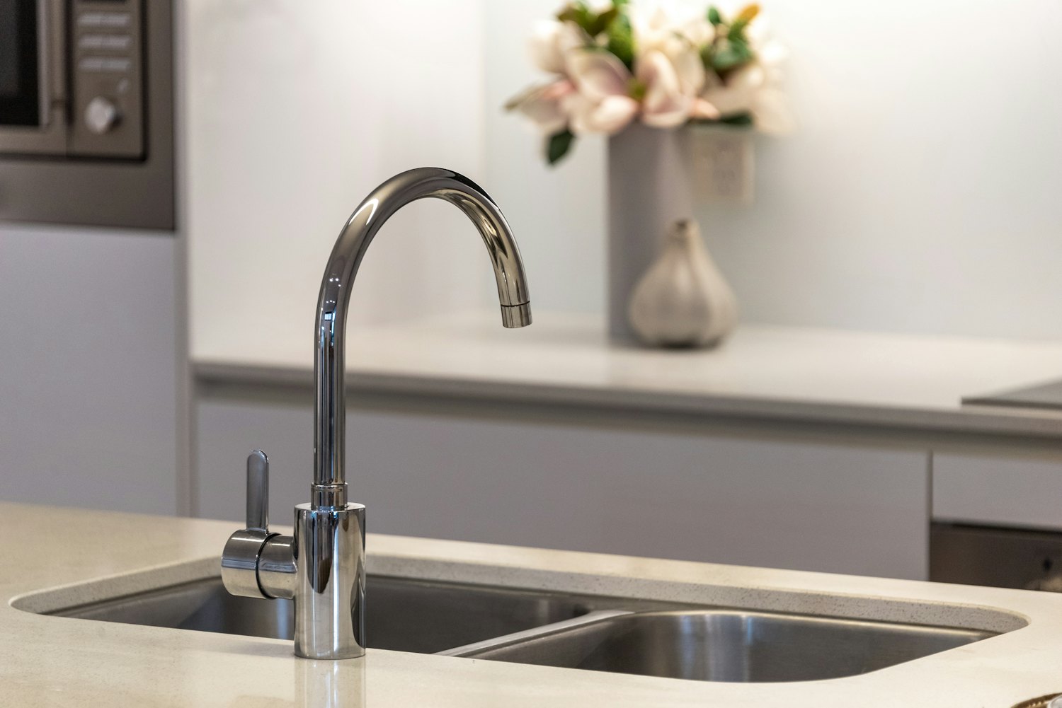 A stainless-steel kitchen faucet — point-of-use treatment sits at the tap where you drink and cook, which is where most health contaminants need to be addressed.